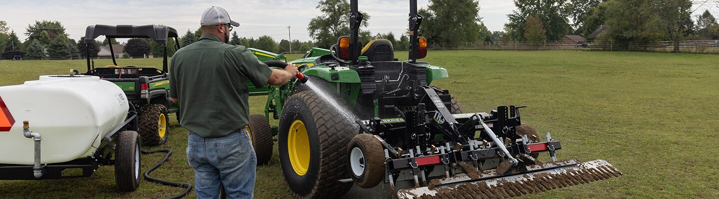 Man using an ABI Attachments Compact Water Trailer to clean a TR3