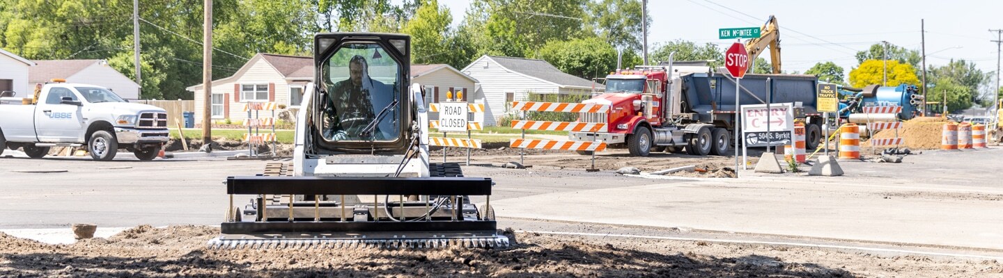 ABI Attachments SR2 grading ground at a construction site