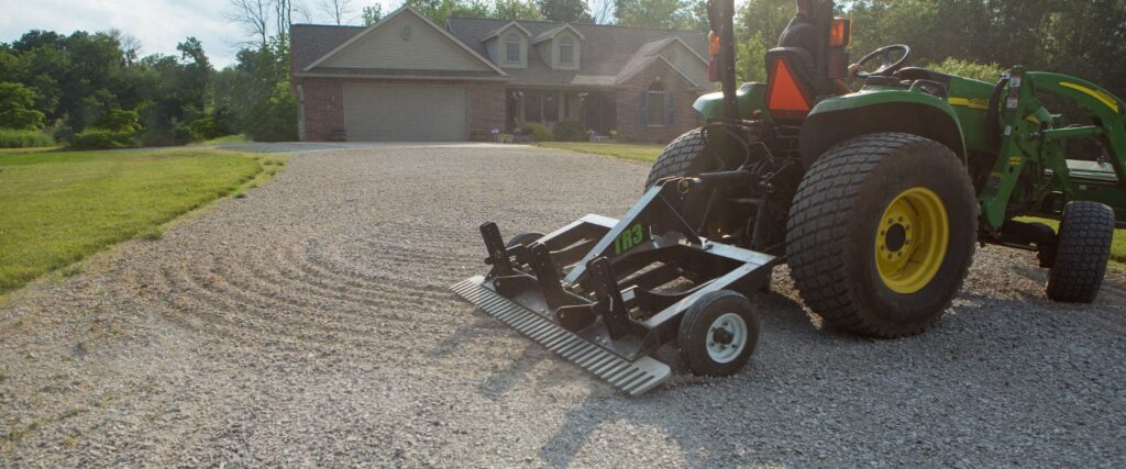 ABI Attachments TR3 grading a gravel driveway