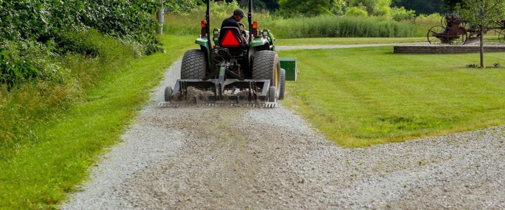 ABI Attachments TR3 grading a gravel driveway