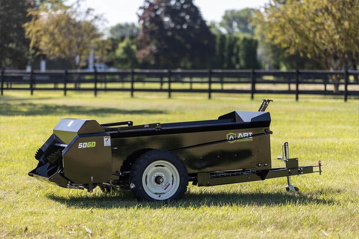 ABI Attachments 50 Cubic Foot Ground Drive Manure Spreader in a field