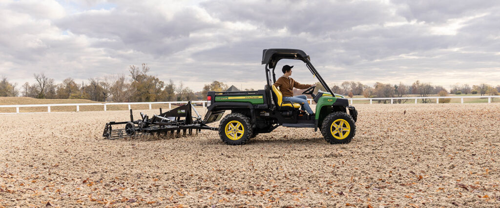 Synthetic footing attachment- SportPro is attached to a green ATV/UTV.