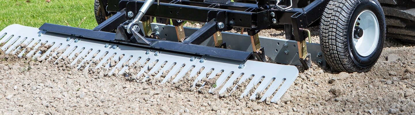 ABI Attachments TR3 Landscape Rake being used for gravel maintenance