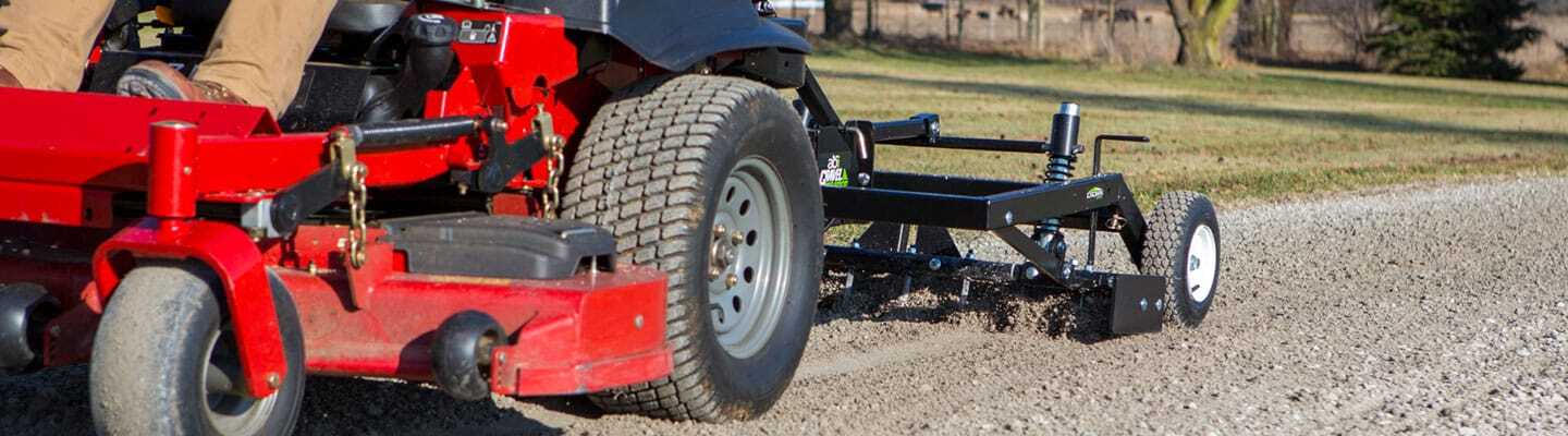 ABI Attachments Gravel Grader doing maintenance on a gravel pathway while being pulled by a riding lawnmower