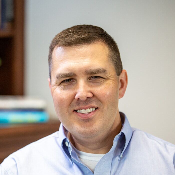 Jim Catalano, CEO of ABI Attachments, wearing a light blue shirt and smiling, known for his passion for innovation and commitment to the ABI brand.
