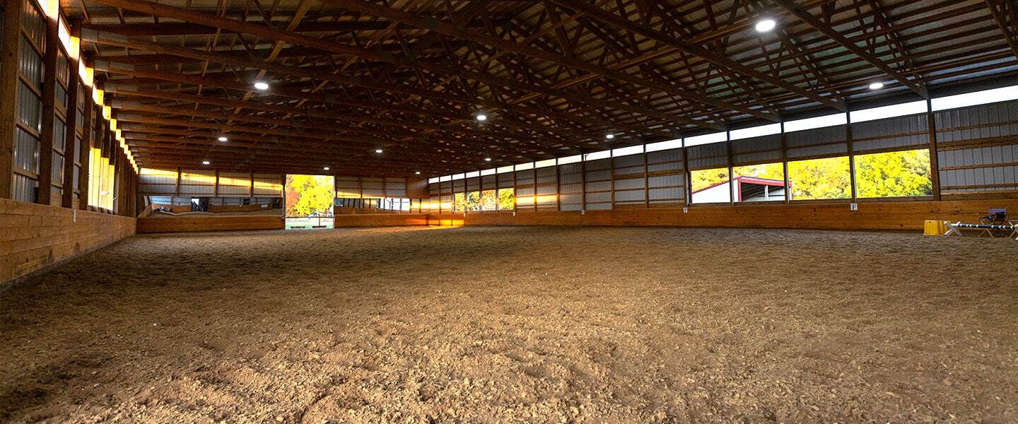 Indoor synthetic footing equine arena