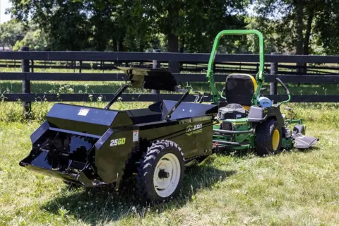 ABI Attachments 25 Cubic Foot Ground Drive Manure Spreader attached to a riding lawnmower