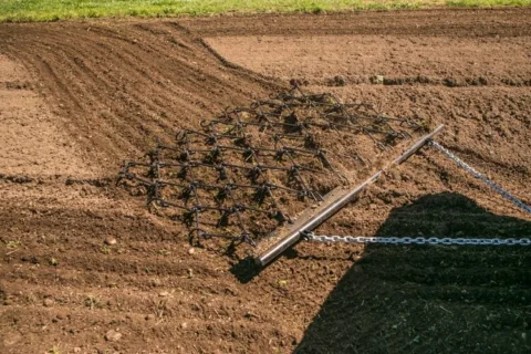 Pull Behind Chain Harrow For ATV Tow Vehicles in dirt.
