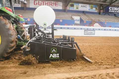 An ABI Speedmaster arena drag grooming the arena at the Lazy E Arena