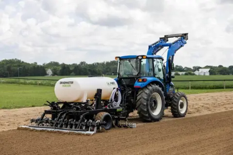 Dragmaster Horizon being pulled by a tractor in an outdoor arena