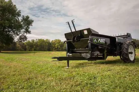 Pull type 85 ground drive manure spreader being displayed.