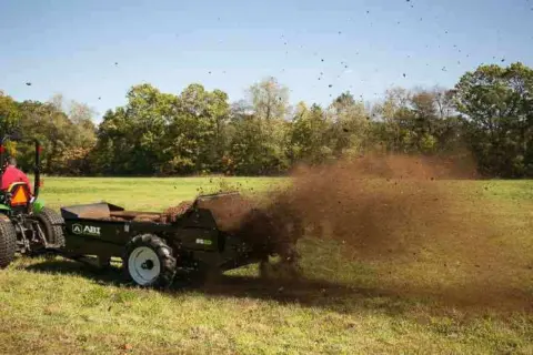 Tractor Pull behind 85 Ground drive manure spreader in pasture