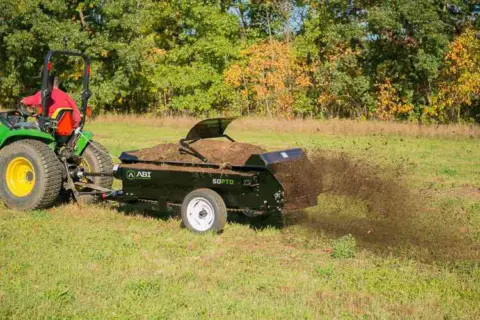 Tractor 50 PTO manure spreader shredding manure