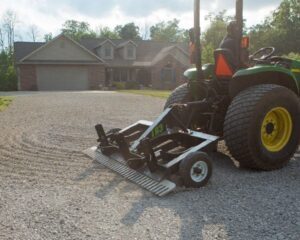ABI Attachments TR3 grading a gravel driveway