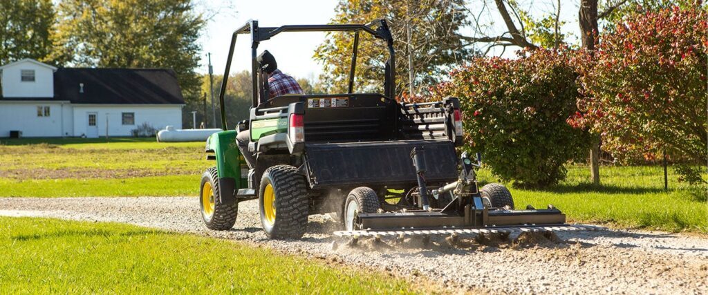 ABI Attachments Gravel Rascal Pro scarifying a gravel pathway