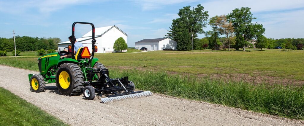 ABI Attachments TR3 grading a gravel pathway while attached to a tractor