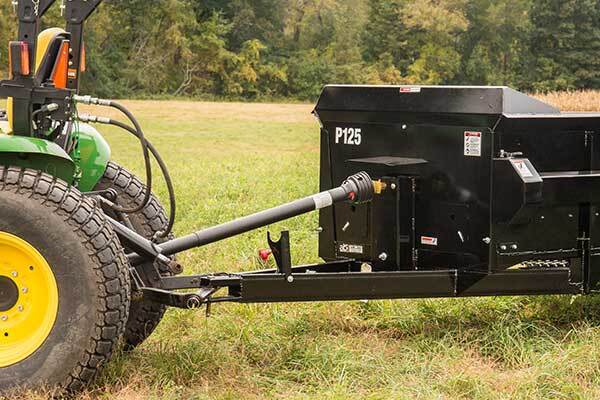 Manure Spreader PTO being dragged in the grass by the tractor.