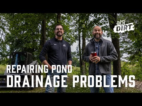 "Repairing Pond Drainage Problems" in white and bold font. In the top right corner, it says "ABI Dirt", a YouTube series presented byy ABI Attachments. This displays 2 men standing and smiling in the outdoors.