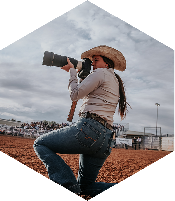 Hailey Rae taking a photo, on her knee.