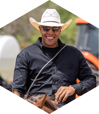 ABI Pros Ambassador Hex - Shad Mayfield - He is riding a horse with a black shirt on and wering a cowboy hat.