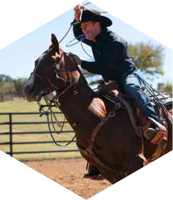 ABI Pros Ambassador Hex - Trevor Brazile - He is riding a horse with a rope in his hand.